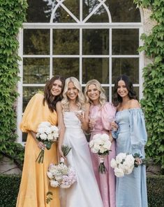 the bridesmaids are all wearing different colored dresses