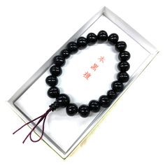 Black Kokutan Ebony Wood Japanese Juzu Bracelet Material : Kokutan (Ebony) Wood, Silk elastic cord Wrist size : 6.7in (about 17cm) We adjust the size to your wrist for fee. Head bead : about 12mm Main beads : about 8mm / 10mm Two Small beads : about 7mm / 8mm Handmade in Kyoto, JAPAN Ebony is a dense black / brown hardwood, most commonly yielded by several different species in the genus Diospyros, which also contains the persimmons. Ebony is dense enough to sink in water. It is finely-textured and has a very smooth finish when polished, making it valuable as an ornamental wood. It's very fit for as a gift or souvenir. In Japan, Buddhists have Prayer beads (Juzu, Nenju). Kyoto is famous as a producing center of Prayer beads. Maintenance Take off when you shower and before going to bed. The Traditional Black Beaded Bracelets For Meditation, Traditional Black Beaded Bracelets As Gift, Traditional Black Bracelet Gift, Traditional Black Bracelet As Gift, Traditional Black Bracelet For Gift, Traditional Black Wristband As A Gift, Spiritual Black Hand-strung Wristband, Traditional Handmade Black Wristband, Traditional Black Adjustable Wristband