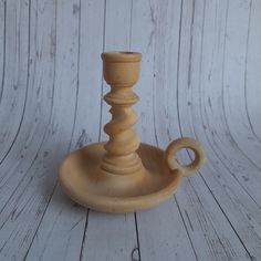 a small wooden candle holder sitting on top of a table