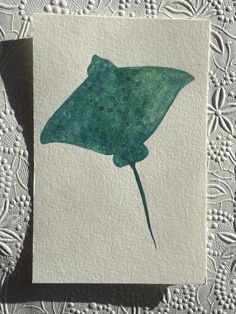 a card with a large green stingfish on it's front and back side