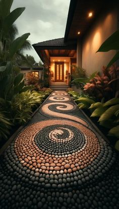 a walkway made out of rocks and pebbles leads to a house