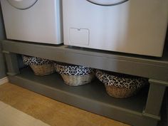 the washer and dryer are sitting next to each other on the shelf in the laundry room