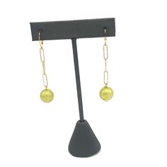 Introducing our Chartreuse Aurora Chain Cuff Earrings – the perfect combination of style and sophistication. These unique earrings feature a vibrant chartreuse bead and a sleek cuff design. Elevate any outfit and make a statement with these must-have accessories. Earrings measure 2 3/8" long and 1/2" wide. Hypoallergenic gold plated leverback cuff style earwires. Earrings are made with vintage lucite parts that were made in Rhode Island in the 1960's - early 80's by Best Plastics. Modern Earrings With Adjustable Chain For Party, Elegant Yellow Metal Earrings, Chic Beaded Chain Jewelry For Formal Occasions, Chic Formal Beaded Chain Jewelry, Green Metal Beaded Earrings For Party, Green Metal Beaded Party Earrings, Elegant Adjustable Beaded Earrings With Beaded Chain, Green Drop Earrings For Party, Green Linear Earrings For Parties