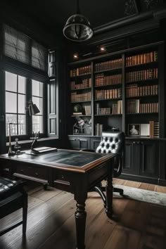 an old fashioned desk in front of a large bookcase with lots of books on it