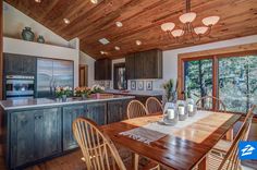 a kitchen and dining room with wood ceilinging