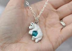 "A perfect gift for yourself or the wolf lover in your life! This dashing double sided white wolf was hand sculpted from polymer clay and painted with acrylic paints and metallic rub, then finished with a durable sealant. From ear to tail the wolf measures approximately 1 inch Included is a crackled bead of your color choice, gem \"N\" is the color shown with the wolf in the example photos. **NOTE** Your order is made to order and is unique, I will usually have your item made and in the mail wit White Clay Jewelry As A Gift, Whimsical White Resin Jewelry, Hand Painted White Clay Jewelry, Personalized White Polymer Clay Jewelry, Hand Painted White Polymer Clay Jewelry, Wolf Necklace, White Wolf, Colored Gems, The Wolf