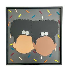 two paper cutouts of gorillas with sprinkles on them in a shadow box