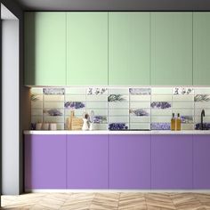 an empty kitchen with purple and green cabinets