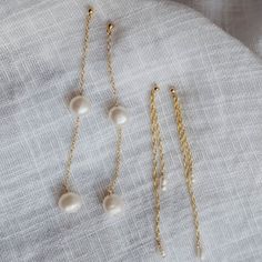 The enchanting Sirena earrings.. Button pearls strung on our dainty cable chain. These will make the perfect accessory for your after beach dinner or summer weddings. Make it a pair with the Sirena Necklace. - Made with 14k gold filled material - 6-7mm pearls - Ball stud with a 9mm post Please note: as pearls are naturally occurring, no two pearls will look the same. We'll try our best to pair pearls that match well together but your piece will have pearls that are uniquely and organically its own! Click here to view our shop policies, including our current processing times and more shipping information. Gold Linear Earrings With Pearl Charm As Gift, Dainty Linear Earrings With Pearl Charm For Gift, Pearl White Dainty Earrings With Pearl Chain, Elegant 14k Gold Filled Pearl Drop Threader Earrings, Dainty Pearl White Earrings With Pearl Chain, Delicate 14k Gold Filled Earrings With Pearl Chain, Everyday 14k Gold Filled Pearl Chain Earrings, Dainty Gold Linear Earrings With Pearl Charm, Dainty Gold Pearl Linear Earrings