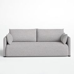 a gray couch sitting on top of a white floor