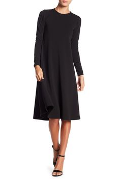 This long sleeve A-line dress is great for the office or dinner and makes for a classy, put-together look. Fit: this style runs small. 43" length (size Small) Crewneck
 Long sleeves A-line skirt 47% polyester, 47% rayon, 6% spandex Machine wash Made in the USA Model stats: 5'10", 32" bust, 25" waist, 36" hip. Model is wearing size Small. Chic A-line Long Sleeve Dress For Fall, Solid Color A-line Long Sleeve Dress For Fall, Classic Long Sleeve Dresses With Flattering Silhouette, Classic Long Sleeve Fall Dresses, Formal Sleek Long Sleeve Fall Dress, Winter A-line Midi Dress For Office, Elegant Long Sleeve Belted Dress For Work, Black A-line Long Sleeve Dress For Winter, Winter Formal A-line Long Sleeve Dress