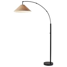 a black and white floor lamp with a beige shade on the top, standing in front of a white background