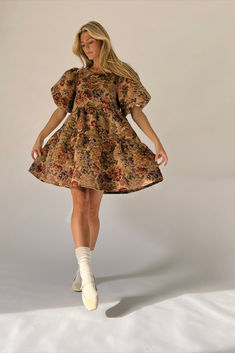 this vintage-inspired puff sleeve mini dress was made for holiday dinners, fall weddings, + any festive gathering in between. it features a stunning rustic floral pattern + has the perfect babydoll silhouette with exaggerated puff sleeves. dress it up with heeled boots, or down with ballet flats. Brown Floral Print Mini Dress For Brunch, Brown Puff Sleeve Mini Dress For Brunch, Vintage Floral Mini Dress For Fall, Brown Puff Sleeve Mini Dress For Spring, Vintage Floral Print Mini Dress For Fall, Spring Brown Mini Dress With Puff Sleeves, Brown Floral Print Mini Dress For Fall, Brown Puff Sleeve Floral Print Dresses, Brown Puff Sleeve Mini Dress