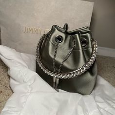 Nwt Jimmy Choo Bon Bon Bag. Comes With Dust Bag. Very Rare Color That Is Difficult To Find In The Us. The Crystal Handle And Silver Hardware Make This A Showstopper Bag! Smoke Free. Pet Free Home! Please See Photos With Very Light Snagging Due To The Embellished Handle. If You Purchase, You Must Store It With The Handle Up Away From The Satin. It’s Not Too Noticeable In Person. Chic Bucket Evening Bag For Party, Chic Party Bucket Evening Bag, Silver Formal Bucket Evening Bag, Elegant Evening Bucket Bag, Elegant Evening Bag With Chain Strap And Bucket Shape, Chic Bucket Evening Bag For Events, Luxury Bucket-shaped Evening Bag For Formal Occasions, Luxury Bucket Evening Bag For Formal Occasions, Luxury Bucket Evening Bag For Events