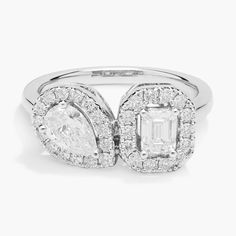 a white gold ring with an oval cut diamond surrounded by smaller round and baguettes