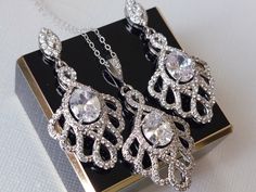 Wedding Cubic Zirconia Earrings and Necklace Bridal Jewelry Set with .925 Sterling Silver Chain. EARRINGS are about 1.65 inch (4.2cm) long from top of earring stud to bottom. CHAIN is 18 inches (45.7cm) long. PENDANT is 1.57 inch (4cm) long including bail. BRIDAL EARRINGS SECTION: https://www.etsy.com/shop/LanaChayka?ref=seller-platform-mcnav§ion_id=11638940 BRIDAL JEWELRY SETS SECTION: https://www.etsy.com/shop/LanaChayka?ref=seller-platform-mcnav§ion_id=25839214 BRIDAL NECKLACES SECTION: https Cubic Zirconia Chandelier Earrings With Intricate Design As Gift, Intricate Cubic Zirconia Chandelier Earrings As Gift, Gift Cubic Zirconia Chandelier Earrings With Intricate Design, Wedding Chandelier Earrings With Intricate Cubic Zirconia Design, Sterling Silver Bridal Earrings With Intricate Design, Silver Bridal Sets With Matching Earrings For Wedding, Statement Bridal Earrings, Bridal Necklaces, Bridal Statement Earrings