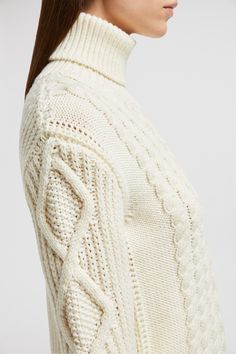 A combination of intricate knitting techniques enrich this wool sweater with a sophisticated texture. Featured in a feminine color palette, the design elevates cold weather looks with its elegant finish. Elegant Turtleneck Sweater In Winter White, Elegant Winter White Turtleneck Sweater, Elegant Textured Knit Sweater For Winter, Elegant Cable Knit Winter Sweater, Elegant Textured Knit Sweater, Luxury White Wool Sweater, Elegant Cream Chunky Knit Sweater, Winter White Wool Cable Knit Sweater, Elegant Chunky Knit Sweater For Fall