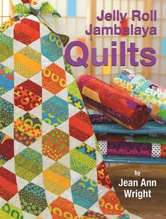 the cover of jelly roll jambaja quilts by jean ann wright, featuring colorful fabrics