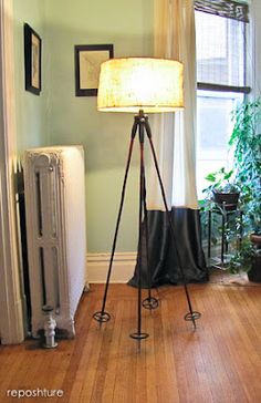 a living room with a lamp, radiator and other items on the floor