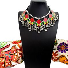 Summer is here! Celebrate with a colorful, playful, fun choker that compliments your wardrobe. Excellent quality, detailed ghungroo dangles, saturated vivid colors. Comfortable silky black cord tie, adjustable to the perfect fit for you. Shop chokers here: https://www.etsy.com/shop/boutiquebymaryam?section_id=23900841 Be sure to visit the rest of my shop here: https://www.etsy.com/shop/boutiquebymaryam Bohemian Necklaces With Motifs For Gift, Bohemian Necklaces With Motifs As Gift, Bohemian Multicolor Tilla Choker, Traditional Multicolor Choker For Festival, Multicolor Choker Necklace For Celebration, Traditional Choker Necklace For Festivals, Multicolor Tilla Choker, Silver Choker Necklace For Festival, Bohemian Jewelry With Motifs For Celebration