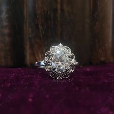 an antique style engagement ring with a center stone