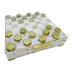 a marble and gold chess board with pieces on it's sides, set against a white background