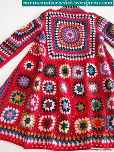 a red crocheted sweater with multicolored squares on it