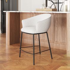 a white chair sitting on top of a hard wood floor next to a countertop