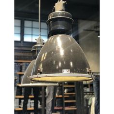 an industrial light hanging from the ceiling in a warehouse