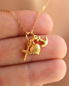 "This is a 14k gold filled charm necklace featuring the symbols Faith, Hope and Love! All three charms come on a shiny cable chain with spring clasp in back. Charms measure 8-10mm. Model is wearing a 16\" length, choose your length. comes in a cute gift box." Valentine's Day Yellow Gold Charm Necklace With Lobster Clasp, Triple Charm, 14kt Gold Jewelry, Anchor Cross, Clean Sterling Silver, Necklaces Women, Faith Jewelry, Anchor Necklace, Clover Earrings