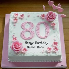 a birthday cake with the number 80 on it and pink flowers in the shape of hearts