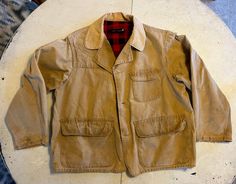 "Vintage slightly stained hunting jacket with inside pocket, 3 front utility pockets and padded right shoulder. It's been recently dry cleaned to remove the worst spots and what's left is minimal and gives a cool worn in authentic vibe to it. I always do my best to capture any flaws in the clothes, be sure to check pictures for details.  Measurements taken while lying flat: chest 22\" shoulder 17.25\" sleeve 21.5\"" Rugged Utility Jacket With Pockets For Hunting, Rugged Hunting Sport Coat With Pockets, Stetson Cowboy Hats, Vintage Hunting, Hunting Jacket, Hunting Jackets, Utility Pockets, Great Bands, Star Shirt