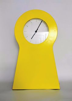 a clock that is shaped like a keyhole