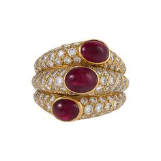 This glamorous ruby and diamond "Three Band" ring has unmistakable Cartier style and craftsmanship. Set among sparkling pavé-set diamonds, the triplet of cabochon rubies of superb color form a diagonal line across three fused bands that balance perfectly on the finger. Artist: Cartier, Paris Country: France Circa: 1990s Size: 6.5 (this ring may be resized, please contact us for further information) Materials: 140 Round brilliant-cut diamonds (approximate total weight 4.25 carats); 3 Oval cabocho 3 Band Ring, Rings With Gemstones, Ruby And Diamond Ring, Vintage Cocktail Ring, Vintage Fine Jewelry, Ruby Diamond Rings, Contemporary Ring, Dome Ring, Ruby Jewelry