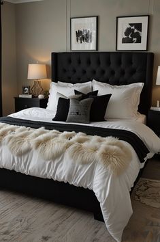 a large bed with white and black comforter in a bedroom next to two lamps