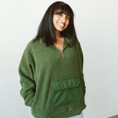 Experience ultimate coziness and style with our plush faux shearling pull-over sweater. Crafted with care and attention to detail, this sweater is designed to keep you warm and snug during chilly days. With a half-zip for easy on and off and a middle pocket for adventures, this pull-over will be your go-to cozy. Cozy Fit Half-zip Fall Sweater, Green Fleece Lined Sweatshirt For Outdoor, Cozy Fleece Jacket With Fleece Lining, Cozy Fleece Jacket For Loungewear, Green Outdoor Sweatshirt With Fleece Lining, Cozy Half-zip Fleece Jacket For Fall, Cozy Sweater With Kangaroo Pocket For Loungewear, Cozy Half-zip Sweatshirt With Pockets, Cozy Fleece Sweater For Outdoor