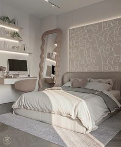 a bedroom with a bed, desk and computer on the wall in front of it