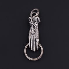 Antique Reproduction Hand Charm Holder Pendant of Sterling Silver - Trademark Antiques Silver Brass Charms Jewelry, Silver Charms Jewelry In Brass, Silver Brass Jewelry With Charms, Symbolic Hand Cast Sterling Silver Jewelry, Victorian Sterling Silver Charm Jewelry, Symbolic Sterling Silver Jewelry, Hand Cast Metal Amulet Jewelry, Antique Silver Spiritual Charms Jewelry, Antique Silver Hand Cast Pendant Jewelry