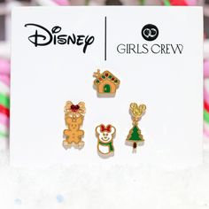 three disney pins sitting on top of a white card with candy canes in the background