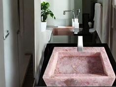 a bathroom sink sitting under a mirror next to a window