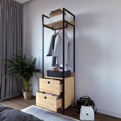 a bedroom with a bed, dresser and clothes rack