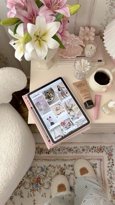 a table topped with a tablet computer next to a white teddy bear