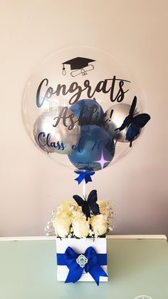 congratulations balloon with blue and white flowers in it