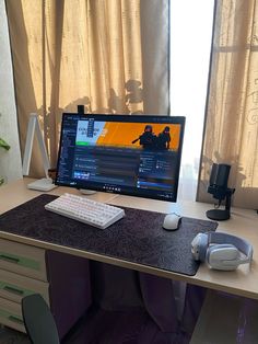 a computer monitor sitting on top of a wooden desk next to a keyboard and mouse