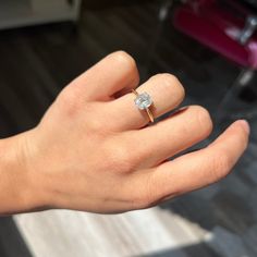 a woman's hand with a diamond ring on it