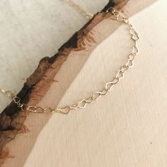 Wrap up in this dainty heart chain choker!  More than just a basic chain, the detail of these heart shaped links will leave you swooning! Bonus: This choker can double as a wrap bracelet!  14k goldfilled or sterling silver chain spring clasp closure Measures 12.5" w/ additional 2.5" extension chain Delicate Chain Heart Necklace In 14k Gold Filled, Adjustable Delicate Heart Chain Necklace, Minimalist Heart Necklace With Delicate Adjustable Chain, Dainty Adjustable Heart Necklace With Delicate Chain, Dainty Heart Bracelet With Delicate Chain For Valentine's Day, Dainty 14k Gold Heart Necklace With Adjustable Chain, Delicate 14k Gold Heart Necklace With Adjustable Chain, Dainty Adjustable Open Heart Necklace, 14k Gold Filled Minimalist Heart Necklace With Delicate Chain