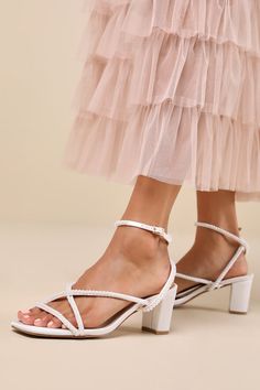 From cute date nights to wedding invites, step out with confidence in the Lulus Makenna White Pearl Satin Strappy Ankle Strap Low Heel Sandals! These wear-with-anything sandals have a sleek woven satin construction that shapes a trendy square footbed with a slender toe strap and crisscrossing vamp straps. An adjustable ankle strap sprouts from the sides and secures with a shiny gold buckle, all atop a cute block heel. Gleaming faux pearl details throughout lend an extra fabulous finish. 2. 5" wrapped block heel. Light cushioned insole. Felted rubber sole has nonskid markings. Man made materials. Imported. Lulus | Makenna White Pearl Satin Strappy Ankle Strap Low Heel Sandal Heels | Size 8. Cute Date, Sparkly Shoes, Pearl Details, Low Heel Sandals, Sandal Heels, Size 11 Heels, Wedding Heels, Graduation Outfit, Heel Sandal