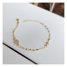 This beautiful rosary bracelet is made of gold plated silver, with cross and Miraculous Medal.  This beautiful elegant bracelet is an ideal gift for Catholic women on all occasions.  If you want to have a bracelet with a deeper meaning, this one is ideal for you Due to its simplicity, it can be worn every day and is easily combined with other jewelry. Lenght of bracelet is 17, 5 plus 4 cm.  Diametar of beads: 3 mm Weight: 3,10 gr For any religious occasions. If you want to see the rest of our se Adjustable Gold Dainty Rosary Bracelet, Gold Dainty Rosary Bracelet, Gold Rosary Bracelet With Round Beads Gift, Gold-plated Rosary Bracelet For Gift, Gold Spiritual Rosary Bracelet With Miraculous Medal, Elegant Rosary Bracelet With Cross For Gift, Elegant Cross Rosary Bracelet As Gift, Gold Rosary Bracelet With Adjustable Chain, Gold Adjustable Chain Rosary Bracelet