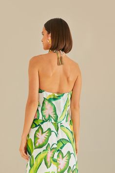 Embrace the tropical vibe with the Summer Foliage Off White Croped Top by FARM Rio. This halter neckline top features a vibrant leafy pattern, evoking the lush landscapes of Brazil. The delicate ruffles and eyelet fabric add a touch of femininity to the piece, while the cropped silhouette keeps it modern and fresh. Perfect for a summer day out, this top will bring a playful and stylish flair to your wardrobe. Composition 55% LINEN 45% VISCOSE Care Instructions MACHINE WASH GENTLE CYCLE, DO NOT B Summer Tropical Print Halter Top Beachwear, Summer Tropical Print Halter Top For Beachwear, Summer Floral Print Halter Top For Poolside, Summer Beachwear Halter Top With Tropical Print, Summer Vacation Halter Neck Top, Tropical Halter Neck Top For Poolside, Green Tropical Halter Top For Summer, Tropical Green Halter Top For Summer, Tropical Print Sleeveless Halter Top For Beach