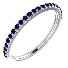 a white gold ring with blue sapphire stones